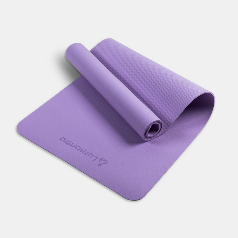 Lilac Lumantra yoga mat rolled partially open, showcasing its eco-friendly texture and non-slip surface.